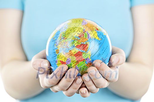 Globe of the planet Earth held in young female hands