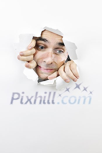 Hole in paper with frightened man looking down through Hole in paper with frightened man looking down through