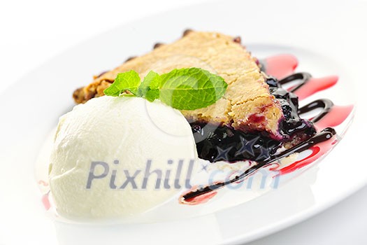 Slice of blueberry pie and vanilla ice cream served with dessert sauces Slice of blueberry pie and vanilla ice cream served with dessert sauces