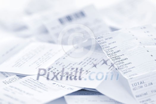 Paper cash register receipts in a lose pile close up