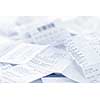 Paper cash register receipts in a lose pile close up