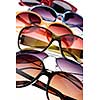 Assorted styles of tinted sunglasses on white background close up