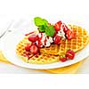 Plate of belgian waffles with fresh strawberries and whipped cream