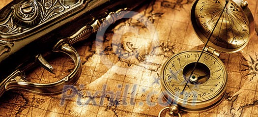 Old vintage retro compass and antique pistol on ancient world map. Vintage still life. Travel geography navigation concept background.