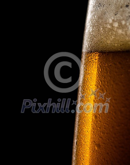 Water drops on a glass of beer. Macro shot. Shallow depth of field. Copyspace on left.