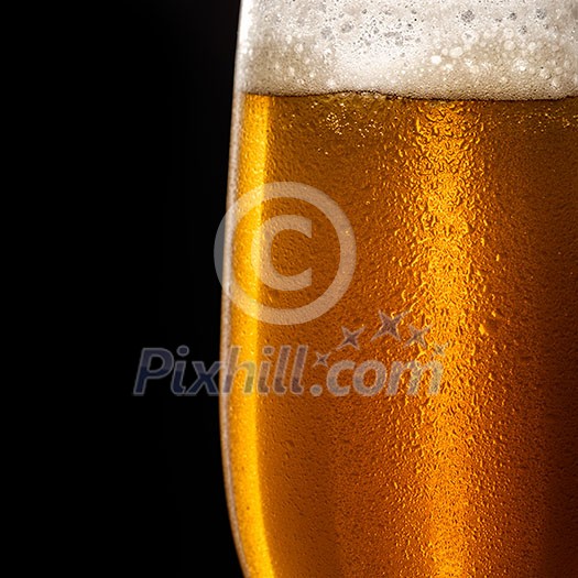 Water drops on a glass of beer. Macro shot. Shallow depth of field. Copyspace on left. Water drops on a glass of beer. Macro shot. Shallow depth of field. Copyspace on left.