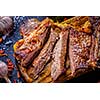 Grilled steak sliced on a cutting board. Entrecote with garlic and chilli on a dark background.