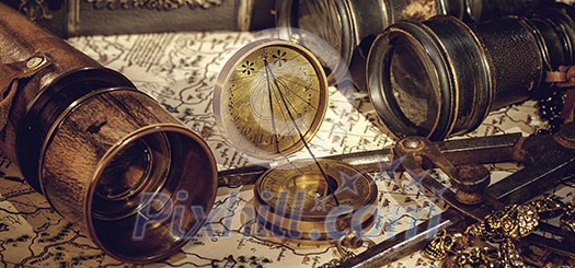 Old vintage retro compass and spyglass on ancient world map. Vintage still life. Travel geography navigation concept background.