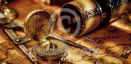 Old vintage retro compass, Spyglass, measuring devices and magnifying glass on ancient world map. Vintage still life. Travel geography navigation concept background.