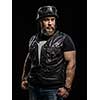 Portrait Handsome Bearded Biker Man in Leather Jacket and Helmet over Black Background