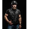 Portrait Handsome Bearded Biker Man in Leather Jacket and Helmet over Black Background