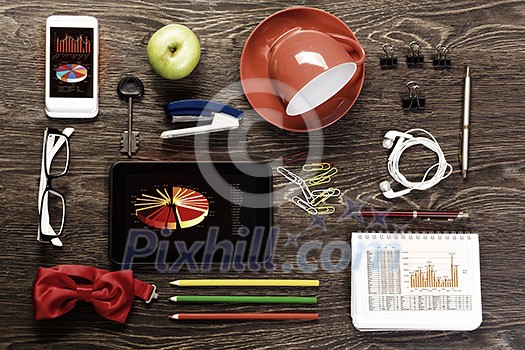 Office workplace with tablet cup mobile phone and stationary