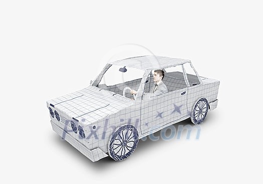 Young man driving car made of sheet of paper