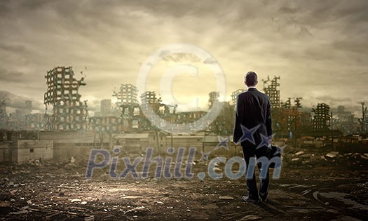 Rear view of businessman looking at ruins of city Rear view of businessman looking at ruins of city