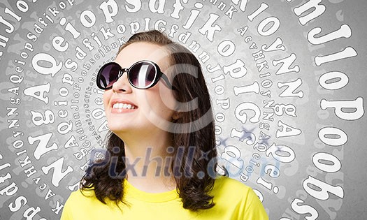 Young girl teenager in sunglasses and yellow shirt
