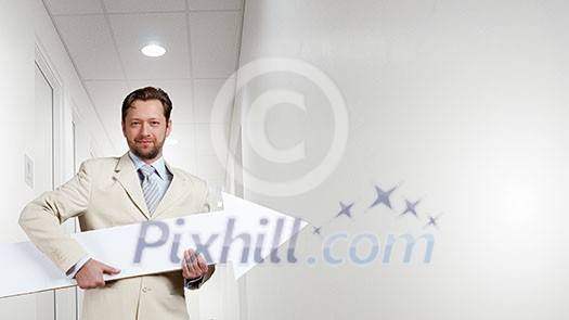 Businessman in suit with white blank arrow in hands