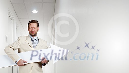 Businessman in suit with white blank arrow in hands Businessman in suit with white blank arrow in hands