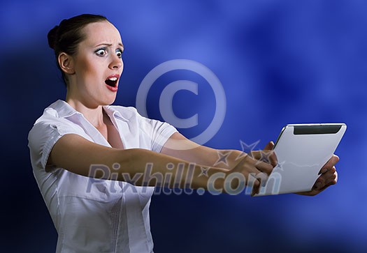Young pretty surprised woman using tablet pc