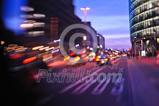 busy traffic scene of street in night  with car traffic and vivid colored city scene