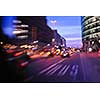 busy traffic scene of street in night  with car traffic and vivid colored city scene
