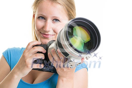 Pretty, female photographer with digital camera - DSLR and a huge telephoto lens (color toned image; shallow DO