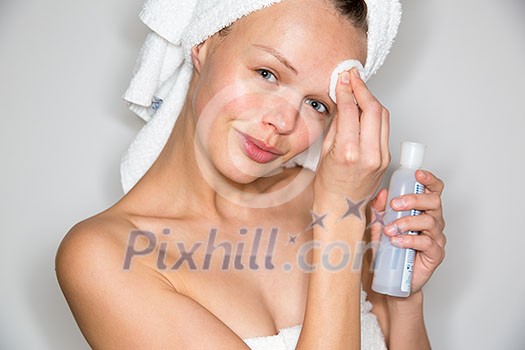 Beautiful brunette woman removing makeup from her face Beautiful brunette woman removing makeup from her face