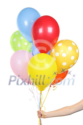 Hand holding colorful helium balloons isolated on white background