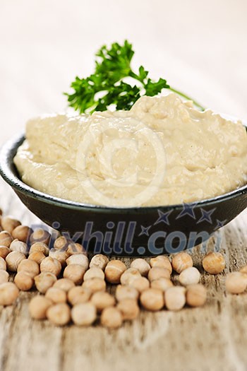 Bowl of fresh hummus with raw organic chickpeas Bowl of fresh hummus with raw organic chickpeas