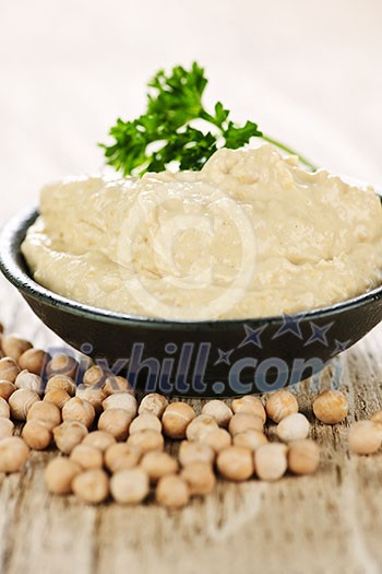 Bowl of fresh hummus with raw organic chickpeas