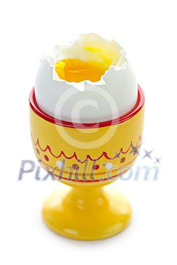 Closeup of soft boiled egg in cup isolated on white background Closeup of soft boiled egg in cup isolated on white background