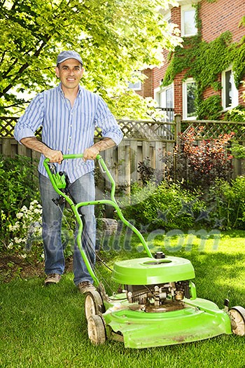 Man with lawn mower in landscaped backyard Man with lawn mower in landscaped backyard