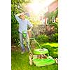 Man taking a break while mowing lawn on hot summer day