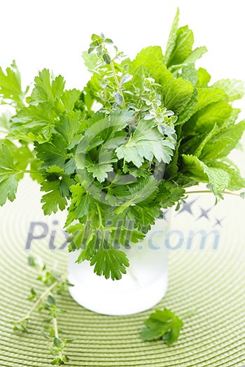 Assortment of fresh organic green herbs in glass Assortment of fresh organic green herbs in glass