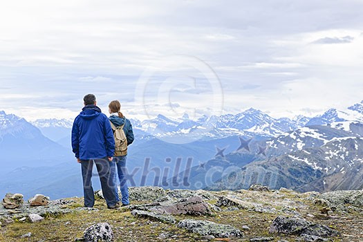 Hikers enjoying scenic Canadian Rocky Mountains view in Jasper National Park Hikers enjoying scenic Canadian Rocky Mountains view in Jasper National Park