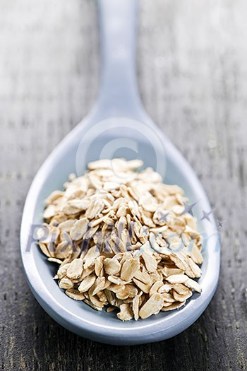 Nutritious rolled oats heaped on a spoon