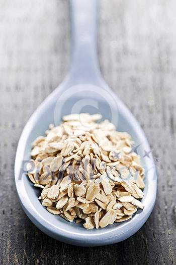 Nutritious rolled oats heaped on a spoon Nutritious rolled oats heaped on a spoon