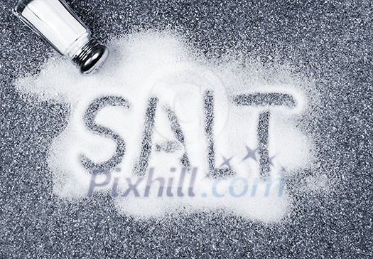 Salt written on counter in spilled salts from shaker Salt written on counter in spilled salts from shaker