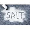 Salt written on counter in spilled salts from shaker