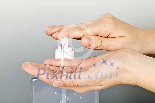 Female hands using hand sanitizer gel pump dispenser Female hands using hand sanitizer gel pump dispenser