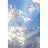Background of blue sky with sun rays and clouds