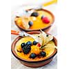 Sweet creme brulee desserts topped with fresh berries