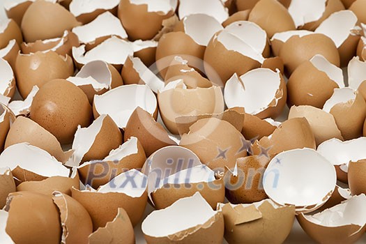 Background of many broken brown empty eggshells