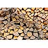 Background of chopped and split firewood logs stacked