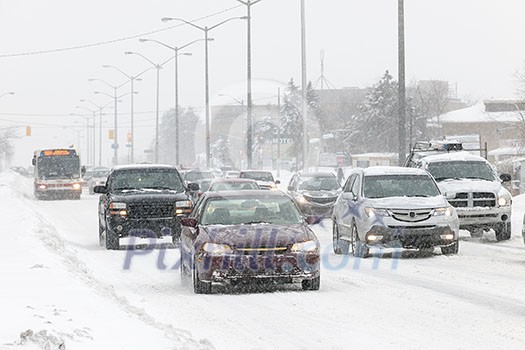 Cars driving on slippery road during heavy snowfall in Toronto