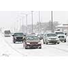 Cars driving on slippery road during heavy snowfall in Toronto