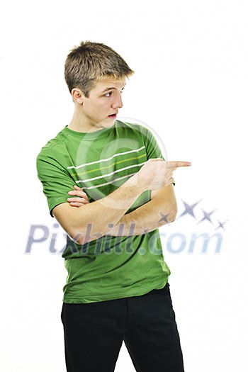 Handsome young man giving directions pointing finger to the side