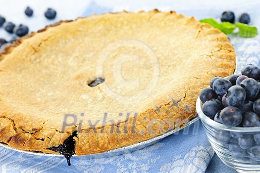 Whole baked blueberry pie with fresh  blueberries