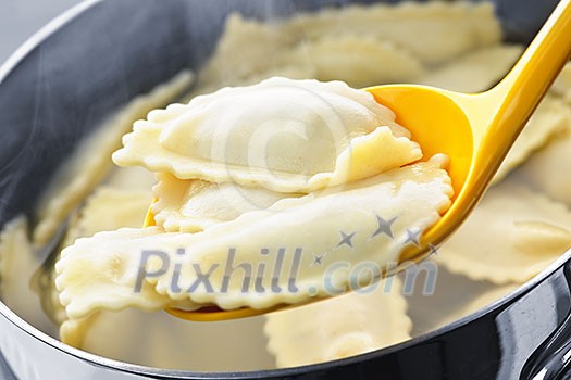 Cooked ravioli lifted from pot on spoon Cooked ravioli lifted from pot on spoon