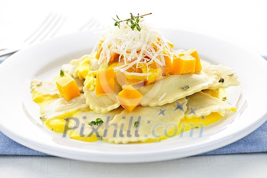 Gourmet squash ravioli dinner served with cheese on plate Gourmet squash ravioli dinner served with cheese on plate