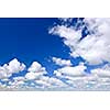 Background of blue sky with white cumulus clouds